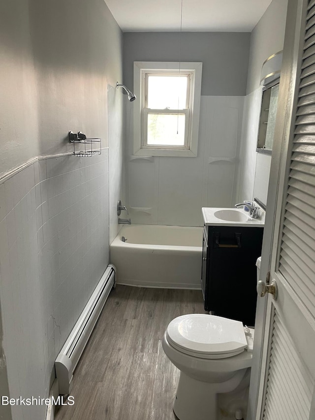 23-27 Gallup St, North Adams, MA 01247 - full bathroom featuring a baseboard heating unit, vanity, wood finished floors, bathing tub / shower combination, and wainscoting
