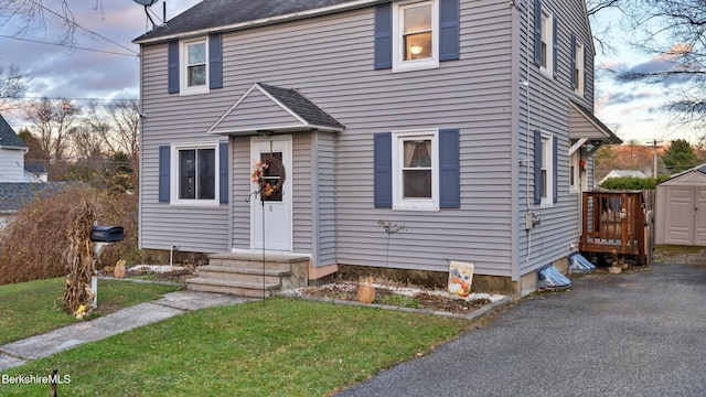 view of front of home featuring a storage unit