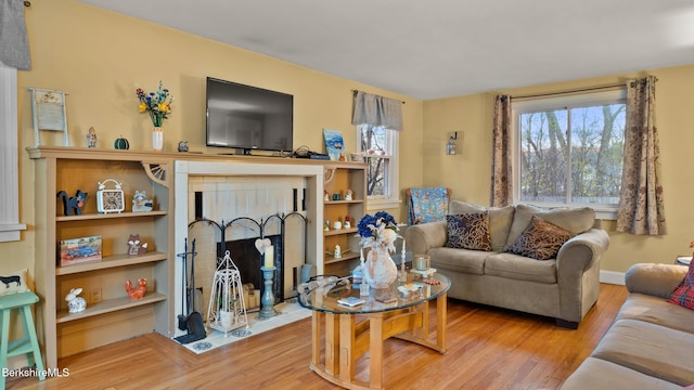 living room with hardwood / wood-style floors and a fireplace