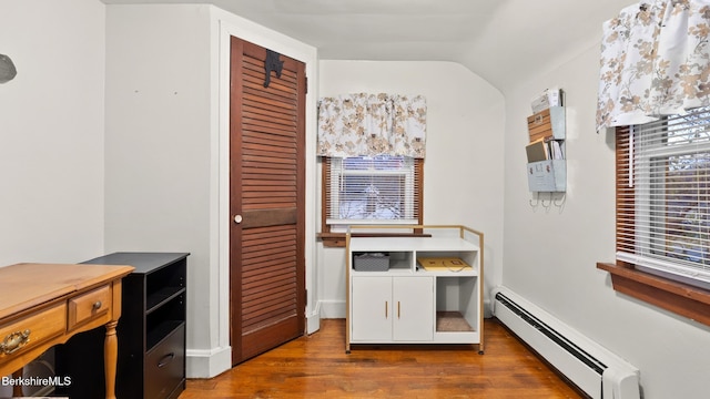 office with vaulted ceiling, a baseboard heating unit, and dark hardwood / wood-style flooring