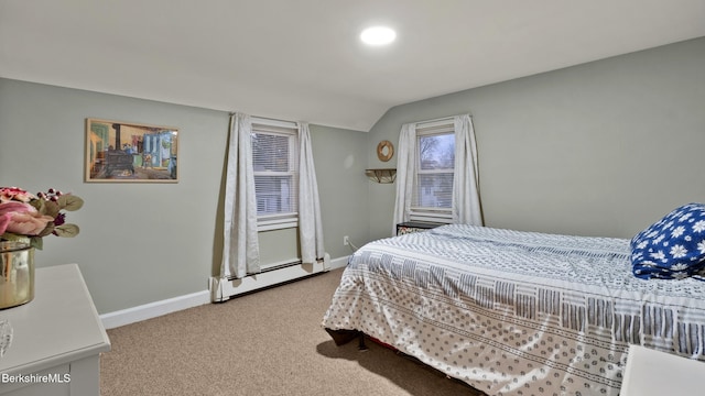 bedroom featuring a baseboard heating unit, carpet floors, and vaulted ceiling