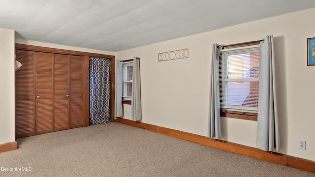 unfurnished bedroom with carpet floors and a closet