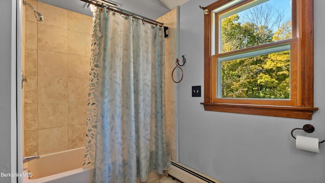 bathroom with shower / bath combo and a baseboard heating unit