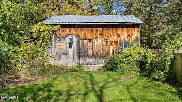 view of outbuilding with a lawn