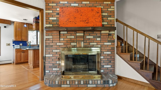 living room with beamed ceiling and light wood-type flooring