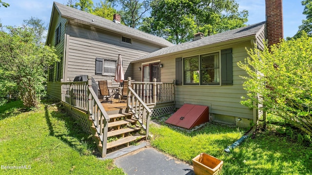 204 Cottage St, Great Barrington, MA 01236 - view of front facade with a deck, a chimney, and a front lawn