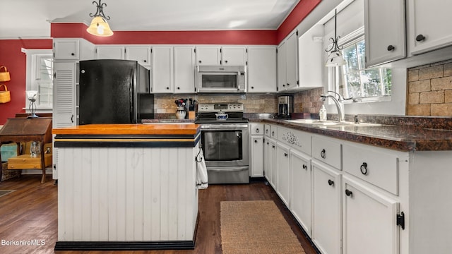 204 Cottage St, Great Barrington, MA 01236 - kitchen with freestanding refrigerator, stainless steel range with electric cooktop, a sink, white cabinets, and decorative backsplash