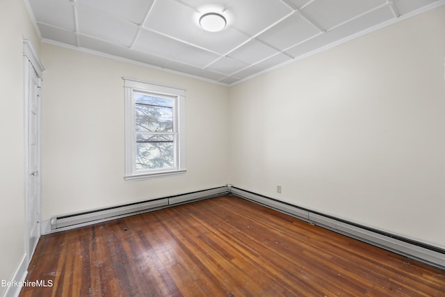 spare room featuring a baseboard radiator and dark hardwood / wood-style flooring