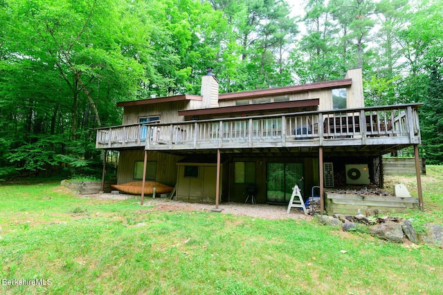 303 Lakeshore Dr, Sandisfield, MA 01255 - rear view of house featuring a wooden deck, a chimney, and a yard