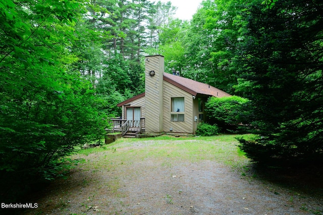 303 Lakeshore Dr, Sandisfield, MA 01255 - view of property exterior with a chimney, a wooden deck, and a forest view