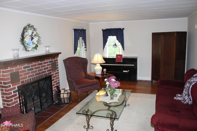 living area featuring ornamental molding, a fireplace, dark wood finished floors, and baseboards