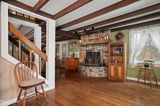 924 Henderson Rd, Williamstown, MA 01267 - living room featuring hardwood / wood-style flooring, beamed ceiling, a stone fireplace, and baseboards