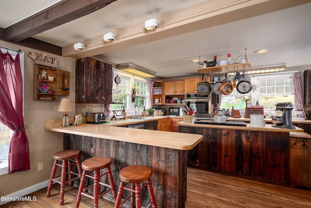 924 Henderson Rd, Williamstown, MA 01267 - kitchen with oven, open shelves, a peninsula, healthy amount of natural light, and beamed ceiling