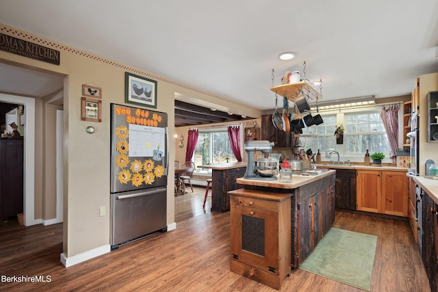 924 Henderson Rd, Williamstown, MA 01267 - kitchen featuring freestanding refrigerator, wood finished floors, light countertops, a kitchen island, and a sink