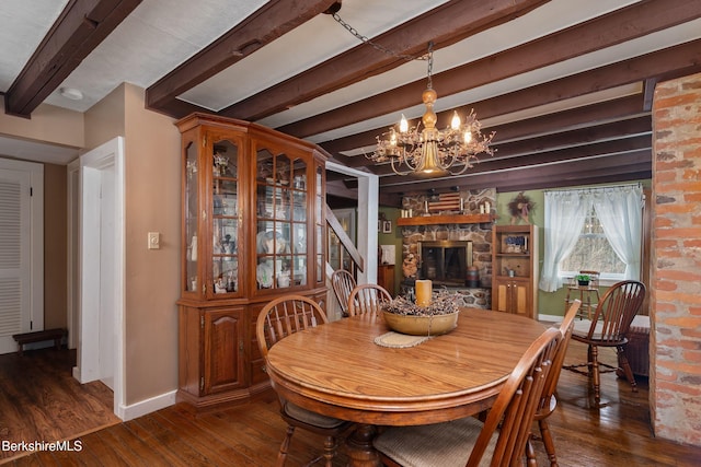 924 Henderson Rd, Williamstown, MA 01267 - dining space featuring beamed ceiling, wood finished floors, a chandelier, baseboards, and a stone fireplace