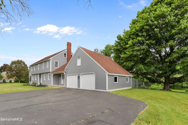 view of front facade with a garage and a front lawn