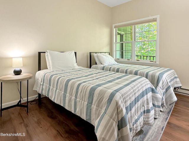 bedroom with dark wood-type flooring