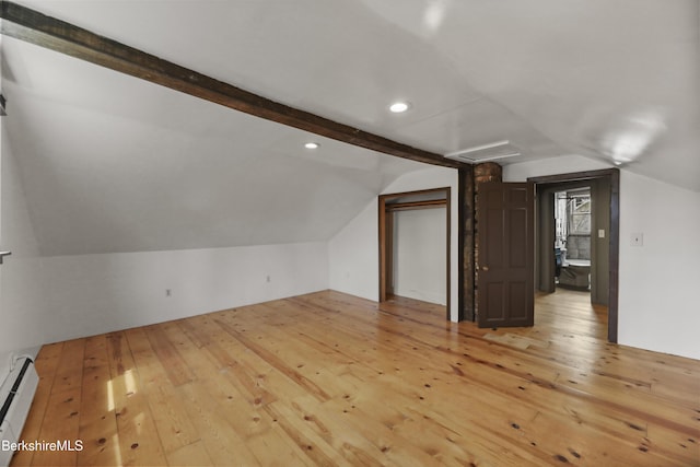 additional living space with vaulted ceiling, light wood finished floors, and a baseboard radiator