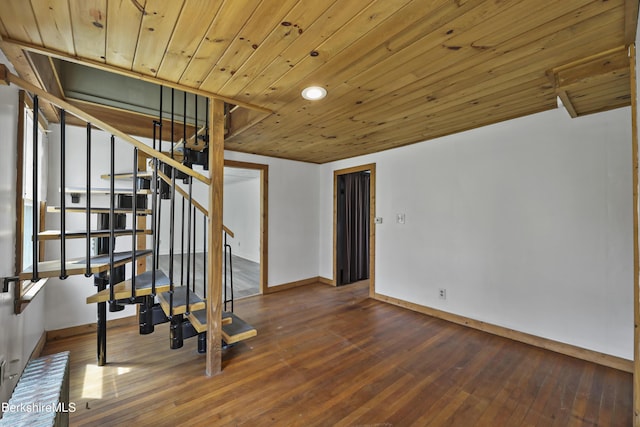 interior space with wood ceiling, hardwood / wood-style floors, baseboards, and stairs