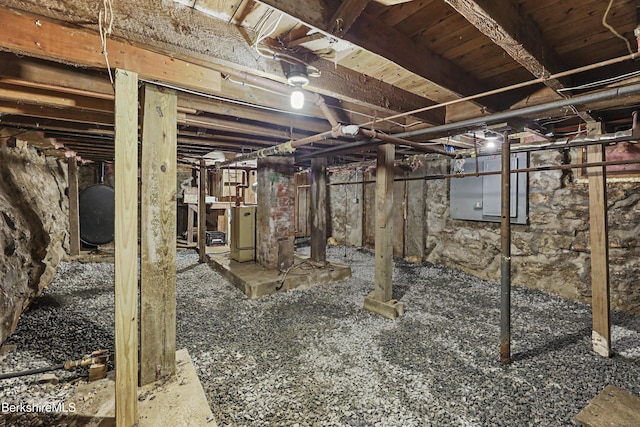 unfinished basement with heating fuel and washer / clothes dryer
