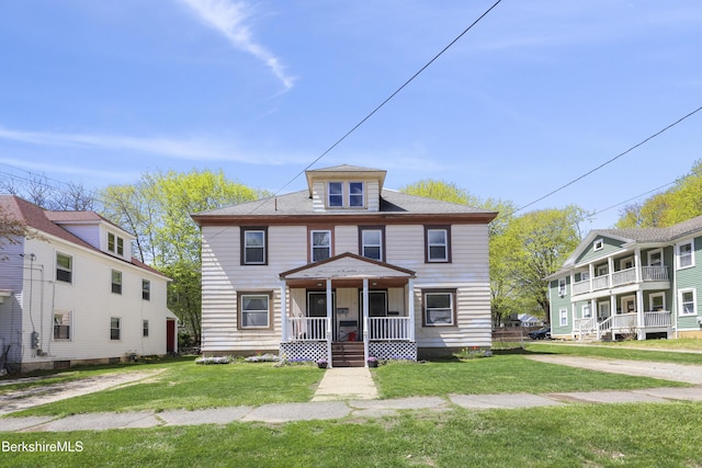 traditional style home with covered porch and a front lawn