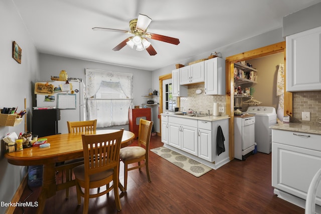kitchen featuring freestanding refrigerator, backsplash, washer and clothes dryer, and light countertops