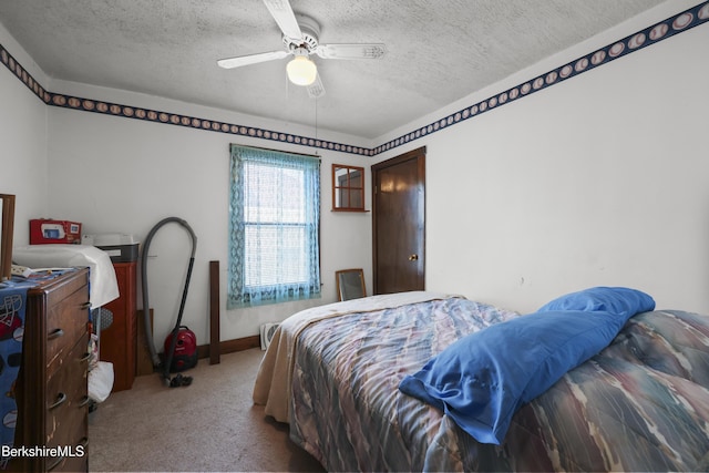 bedroom with baseboards, ceiling fan, carpet, and a textured ceiling