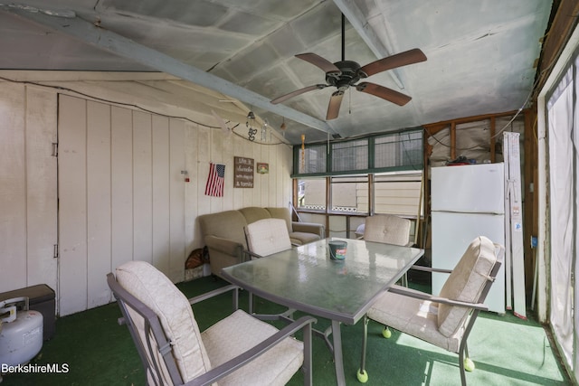 sunroom featuring ceiling fan and outdoor dining space