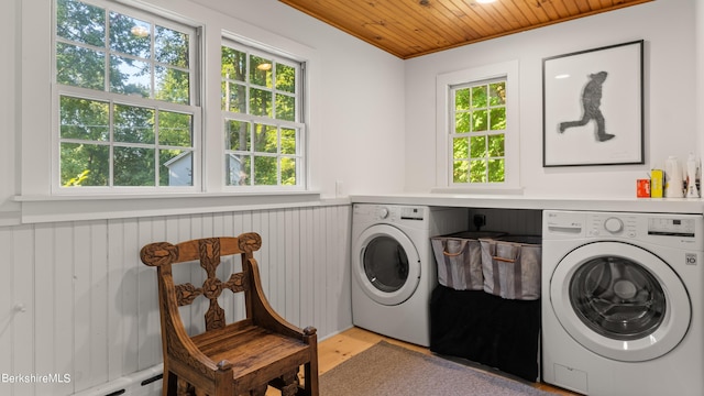 laundry room with washer and clothes dryer, wood ceiling, and crown molding