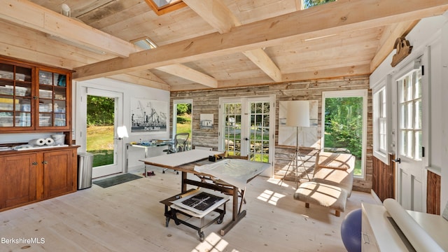 interior space featuring beamed ceiling, wooden ceiling, a wealth of natural light, and french doors