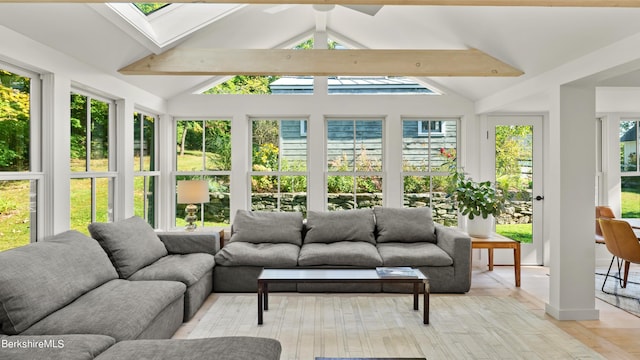 sunroom / solarium with vaulted ceiling with skylight