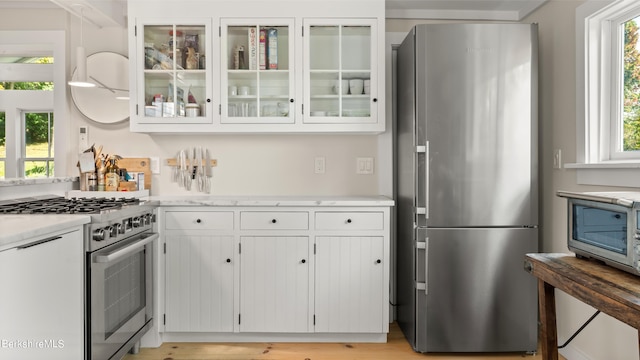 kitchen featuring white cabinets and appliances with stainless steel finishes