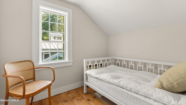 bedroom with hardwood / wood-style flooring and vaulted ceiling