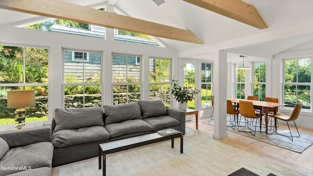 sunroom / solarium featuring lofted ceiling with beams