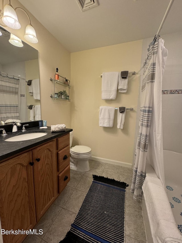 full bathroom featuring tile patterned floors, vanity, shower / bath combination with curtain, and toilet