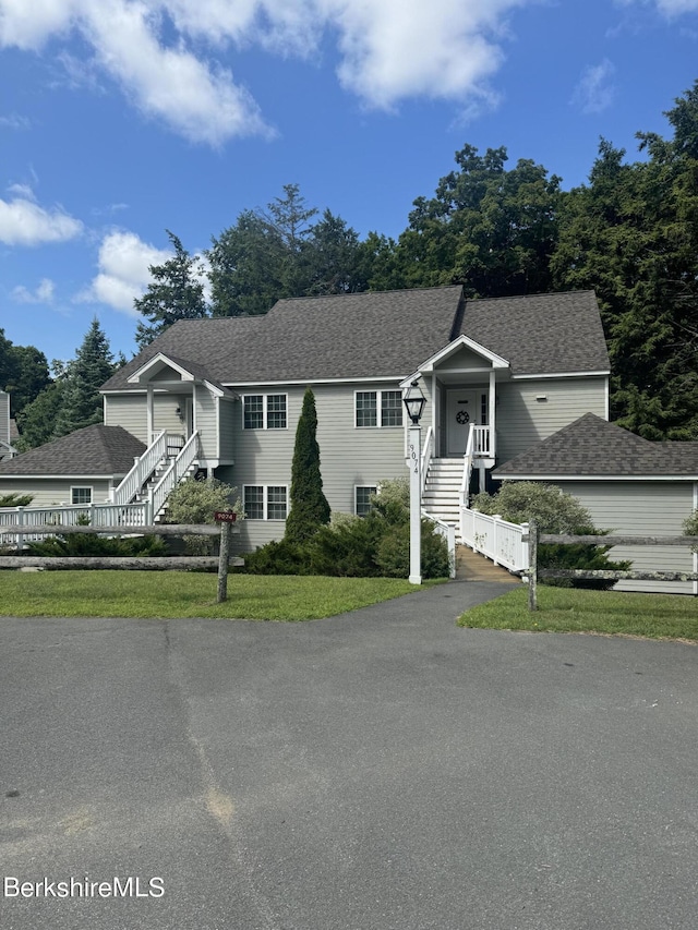 raised ranch with a front lawn