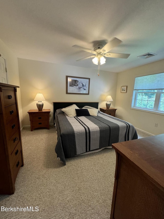 bedroom with ceiling fan and light carpet