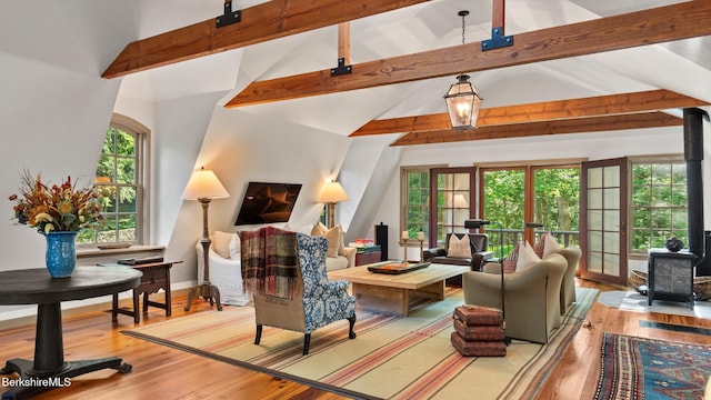232 Giberson Rd, Sheffield, MA 01257 - living room with wood finished floors, healthy amount of natural light, beam ceiling, high vaulted ceiling, and a wood stove