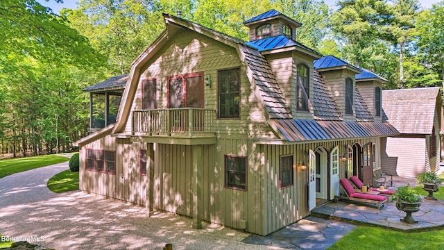 232 Giberson Rd, Sheffield, MA 01257 - view of front of property featuring a standing seam roof, board and batten siding, metal roof, a gambrel roof, and a patio