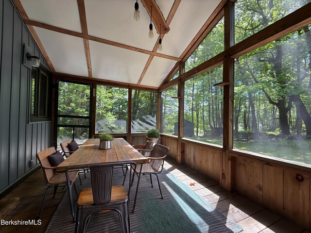 110 Access Rd, Becket, MA 01223 - sunroom featuring healthy amount of natural light, vaulted ceiling, wood walls, and outdoor dining area