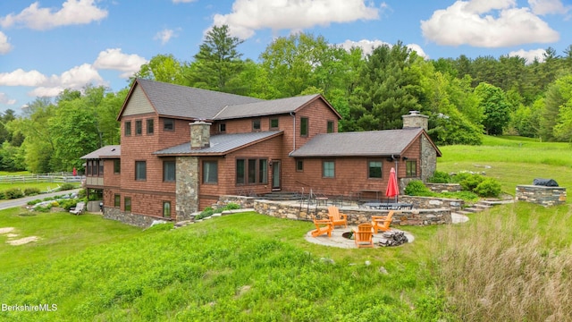 56 Crooked Hill Rd, Alford, MA 01230 - rear view of house featuring a fire pit, a standing seam roof, a yard, and a chimney