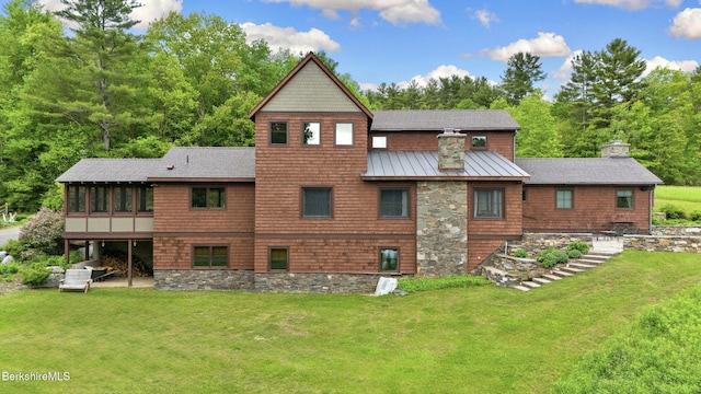 56 Crooked Hill Rd, Alford, MA 01230 - rear view of property with a chimney, a sunroom, a standing seam roof, a lawn, and metal roof