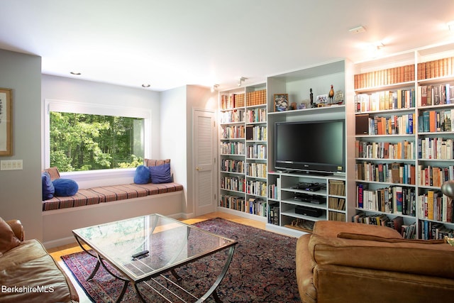 360 Brush Hill Rd, Sheffield, MA 01257 - living room with wall of books, wood finished floors, and baseboards