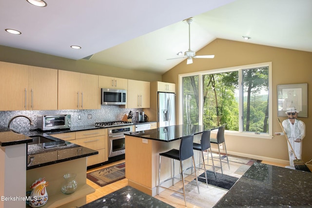 360 Brush Hill Rd, Sheffield, MA 01257 - kitchen featuring stainless steel appliances, light brown cabinets, decorative backsplash, a kitchen bar, and dark stone counters