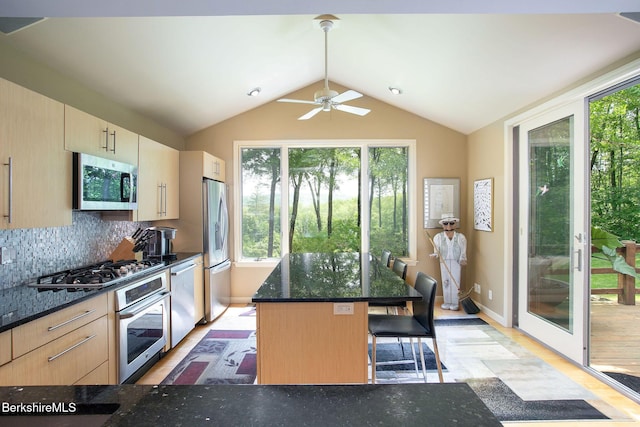 360 Brush Hill Rd, Sheffield, MA 01257 - kitchen with stainless steel appliances, light wood-style flooring, tasteful backsplash, a breakfast bar, and dark stone counters