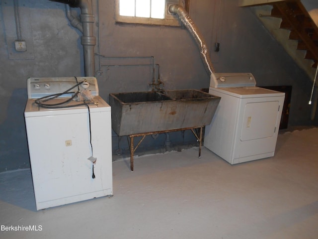 washroom featuring laundry area, a sink, and washing machine and clothes dryer