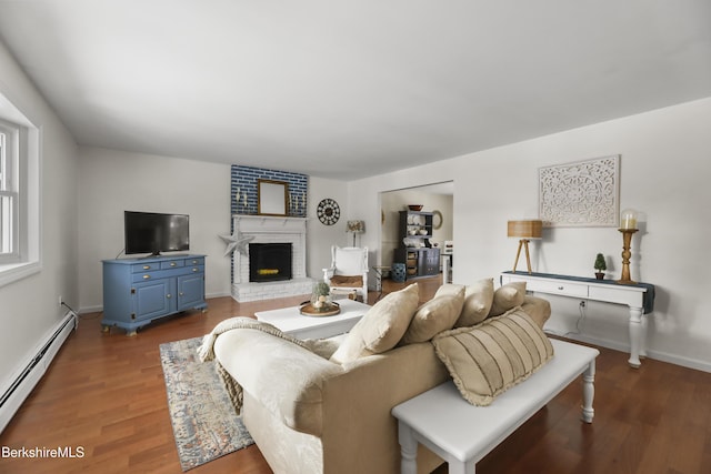 living room with baseboard heating, a fireplace, and dark wood-type flooring