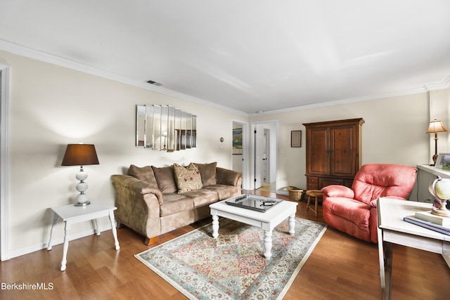 living room with crown molding and hardwood / wood-style flooring