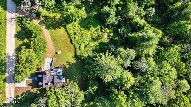 drone / aerial view featuring a wooded view