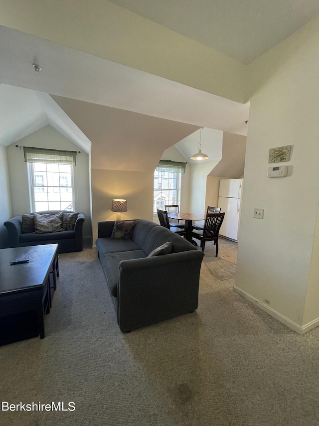 carpeted living room featuring lofted ceiling